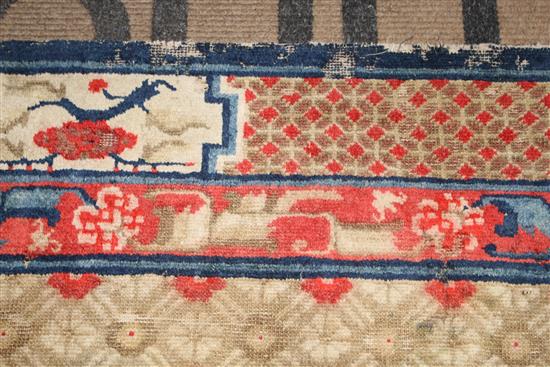 A small Chinese Suiyvan carpet, the fawn ground field woven with a lattice pattern, each cross centred by flowerheads, within a border